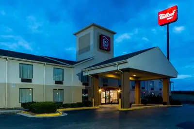a hotel with a sign in a parking lot at Red Roof Inn Morehead in Morehead