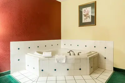 a bathroom with a tub and a sink at Red Roof Inn Morehead in Morehead