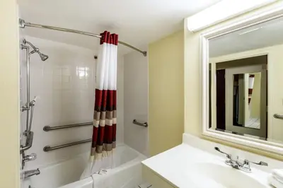 a bathroom with a tub and a sink and a shower at Red Roof Inn Morehead in Morehead