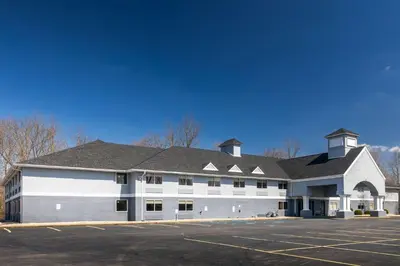 a large white building with a parking lot at Quality Inn Carrollton in Carrollton
