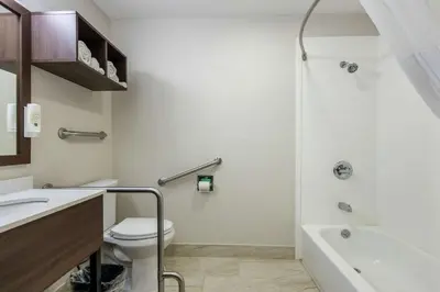 a bathroom with a toilet and a sink and a tub at Quality Inn Carrollton in Carrollton