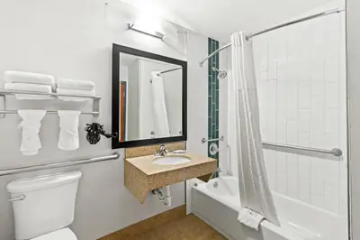 a bathroom with a toilet and a sink and a shower at Quality Inn Dry Ridge in Dry Ridge