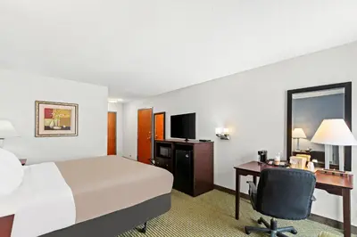 a hotel room with a bed and a desk at Quality Inn Dry Ridge in Dry Ridge