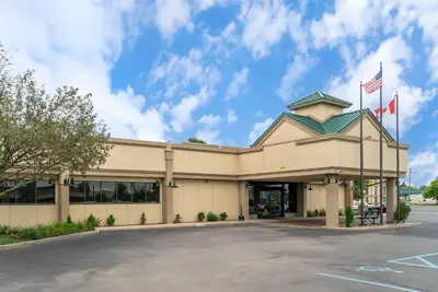 a building with two flags in front of it at Quality Inn & Suites Monroe in Monroe