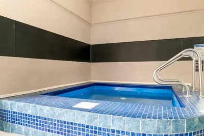 a bathroom with a hot tub with a faucet at Quality Inn & Suites Monroe in Monroe