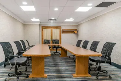 a conference room with wooden tables and chairs at Quality Inn & Suites Monroe in Monroe