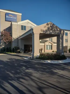 a building with a sign for a hotel at Baymont by Wyndham Flat Rock in Flat Rock