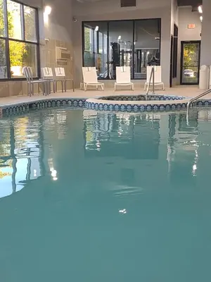 a swimming pool with blue water in a house at Baymont by Wyndham Flat Rock in Flat Rock