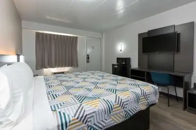 a hotel room with a bed and a flat screen tv at Motel 6-Cincinnati, OH in Cincinnati