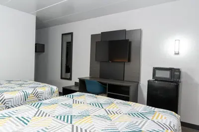 a hotel room with two beds and a tv at Motel 6-Cincinnati, OH in Cincinnati