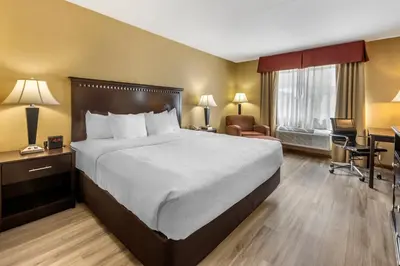 a hotel room with a bed and a desk at Quality Inn Greenville North in Greenville