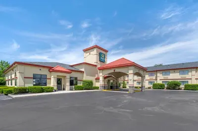 a building with a clock tower in a parking lot at Quality Inn Greenville North in Greenville