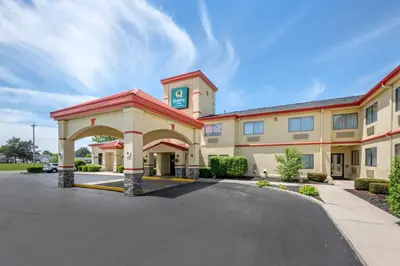 a hotel with a building with a parking lot at Quality Inn Greenville North in Greenville