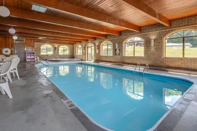 a large swimming pool with blue water in a building at Comfort Inn Millersburg in Millersburg