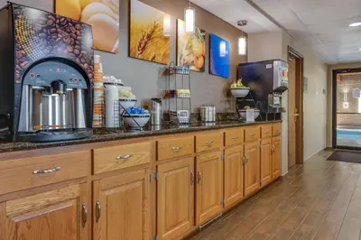 a kitchen with wooden cabinets and a counter top at Comfort Inn Millersburg in Millersburg