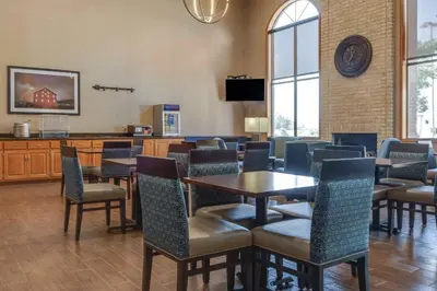 a restaurant with tables and chairs in a room at Comfort Inn Millersburg in Millersburg