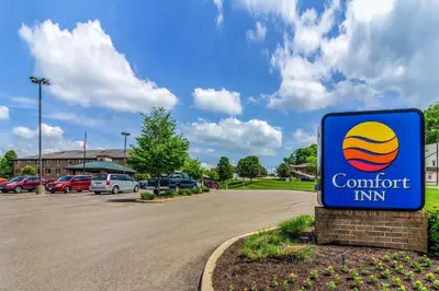 a sign for a comfort inn in a parking lot at Comfort Inn Millersburg in Millersburg