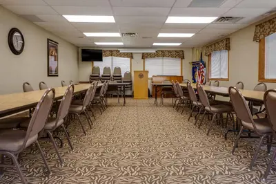 a conference room with tables and chairs and a podium at Comfort Inn Millersburg in Millersburg