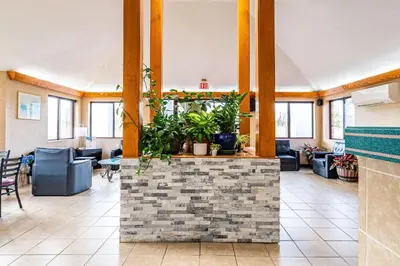 a lobby with a waiting area with plants at Econo Lodge Cleveland Southeast - Kent in Streetsboro