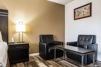 a hotel room with a desk and two chairs at Econo Lodge Cleveland Southeast - Kent in Streetsboro
