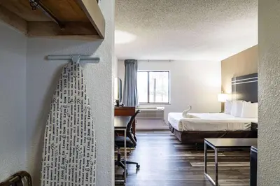 a hotel room with a bed and a desk at Econo Lodge Cleveland Southeast - Kent in Streetsboro