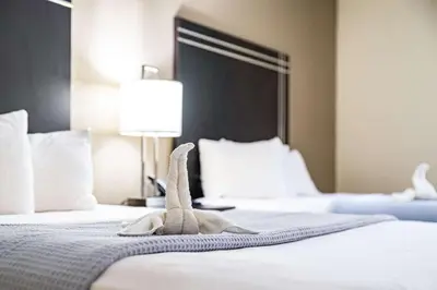 a stuffed animal on a bed in a hotel room at Econo Lodge Cleveland Southeast - Kent in Streetsboro