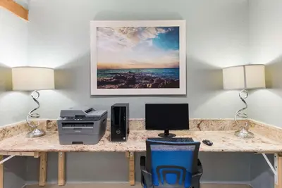 a desk with a printer and a computer on it at Quality Inn Upper Sandusky in Upper Sandusky