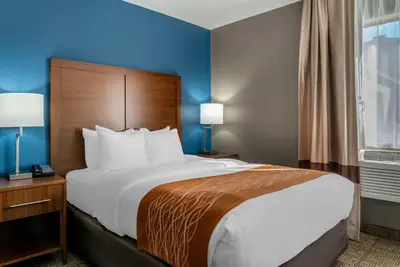 a hotel room with a large bed and a window at Comfort Inn East Oregon - Toledo in Oregon