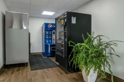 an office with a soda machine and a potted plant at Comfort Inn East Oregon - Toledo in Oregon