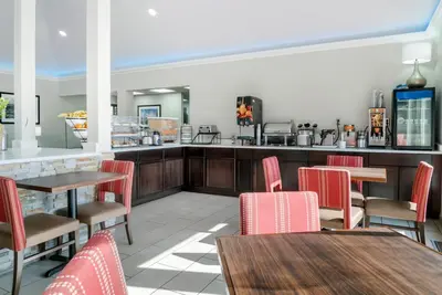 a restaurant with tables and chairs and a counter at Comfort Inn East Oregon - Toledo in Oregon
