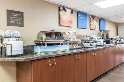 a kitchen with a buffet of food on a counter at Comfort Inn & Suites Piqua-Near Troy-I75 in Piqua