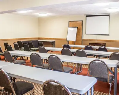 a conference room with tables and chairs and a whiteboard at Quality Inn Elyria in Elyria