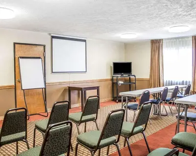 a conference room with tables and chairs and a whiteboard at Quality Inn Elyria in Elyria