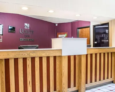 a bar in a restaurant with a wooden fence at Quality Inn Elyria in Elyria