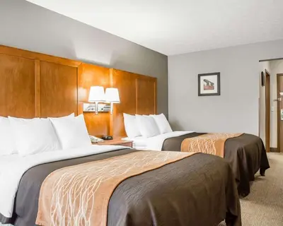 a hotel room with two beds in a room at Comfort Inn Bellefontaine in Bellefontaine