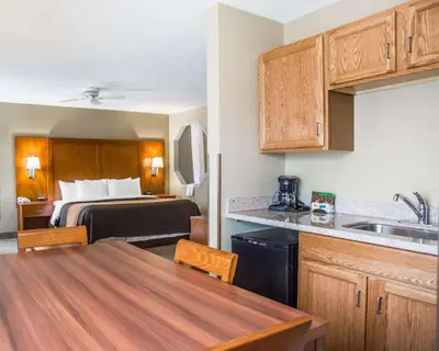a small kitchen with a bed in a hotel room at Comfort Inn Bellefontaine in Bellefontaine