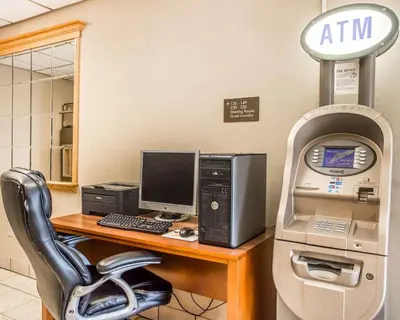 an atm machine sitting next to a desk with a computer at Comfort Inn Bellefontaine in Bellefontaine