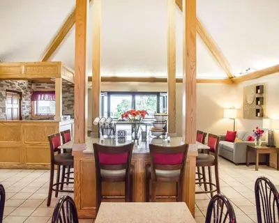 a dining room with a table and chairs at Comfort Inn Bellefontaine in Bellefontaine