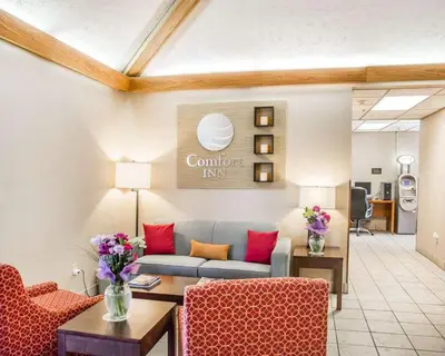 a living room with a couch and two chairs at Comfort Inn Bellefontaine in Bellefontaine