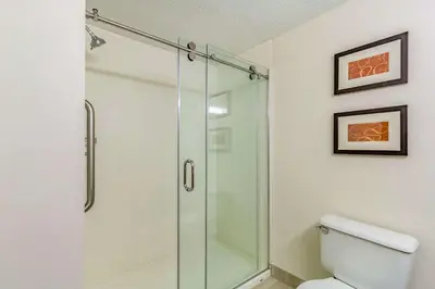 a glass shower in a bathroom with a toilet at Comfort Inn Independence - Cleveland in Independence