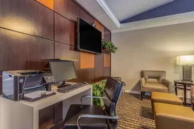 a room with a desk with a computer and a chair at Comfort Inn Independence - Cleveland in Independence