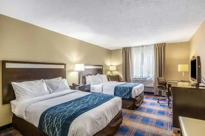 a hotel room with two beds and a television at Comfort Inn Independence - Cleveland in Independence