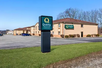 a sign in the grass in front of a building at Quality Inn & Suites Seville in Seville