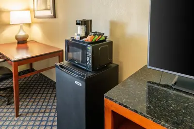 a hotel room with a microwave and a television at Quality Inn & Suites Seville in Seville