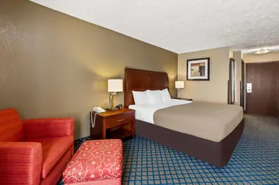 a hotel room with a bed and a couch at Quality Inn & Suites Seville in Seville