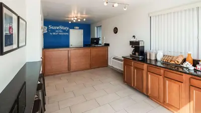 a kitchen with a counter and a refrigerator in a room at SureStay Hotel by Best Western Findlay in Findlay