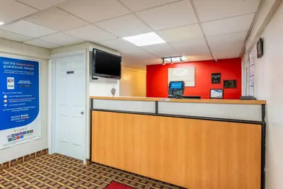 a waiting room with a counter and a tv at Econo Lodge Franklin - Springboro in Franklin