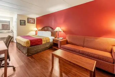 a hotel room with a bed and a couch at Econo Lodge Franklin - Springboro in Franklin