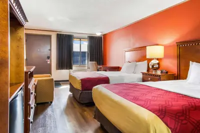 a hotel room with two beds and a television at Econo Lodge in Norwalk