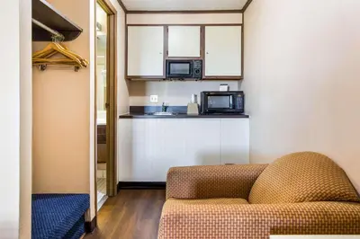 a living room with a couch and a microwave at Econo Lodge in Norwalk